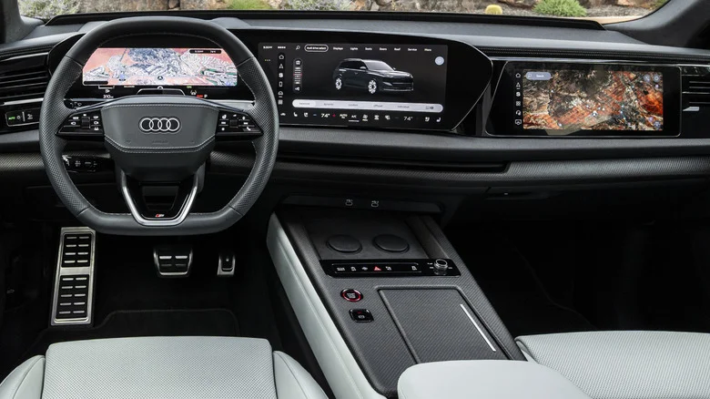 Close-up of the dashboard in the SQ9 with carbon fiber trim and white seats