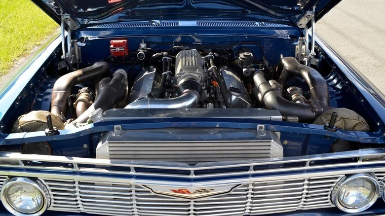 A modified 1961 Chevrolet Impala Bubbletop displays its twin-turbocharged big block V8 engine