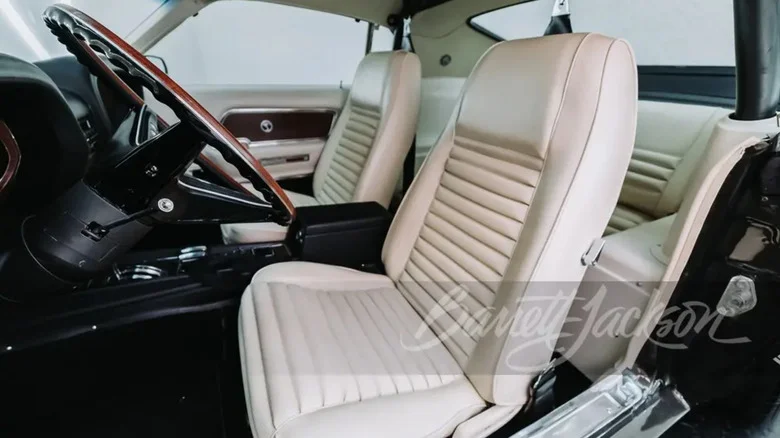 The interior of a 1969 Shelby GT500 with knit white vinyl seats