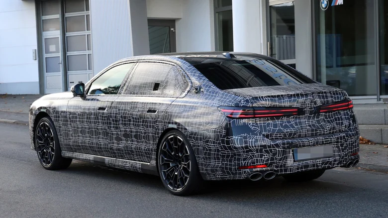 Rear 3/4 view of a camouflaged Alpina B7 prototype